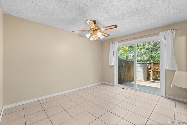 tiled spare room with ceiling fan and a textured ceiling