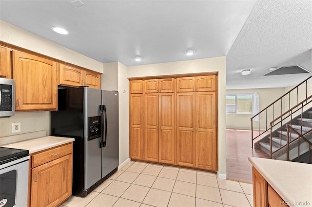 kitchen with stainless steel appliances and light tile patterned floors