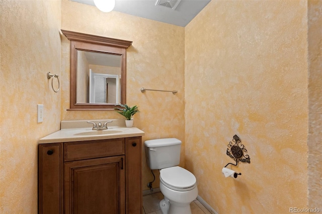 bathroom featuring vanity, tile patterned floors, and toilet