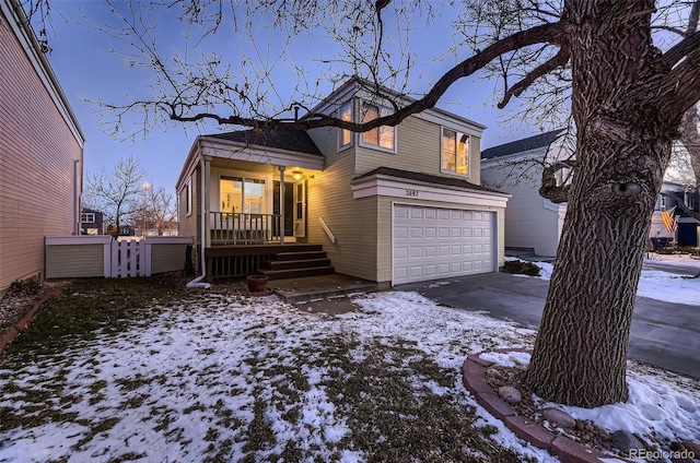 view of front of property with covered porch and a garage