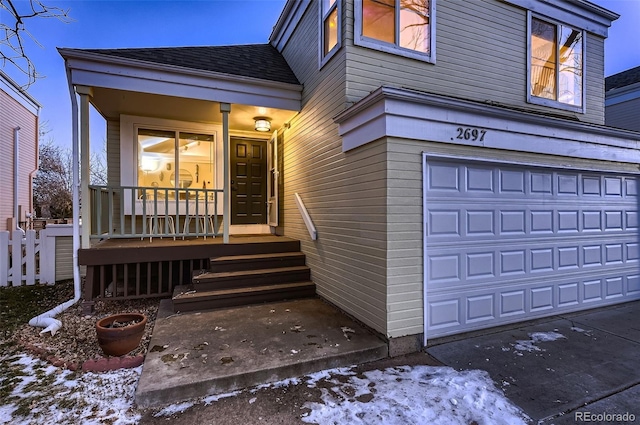 view of front of house featuring covered porch and a garage