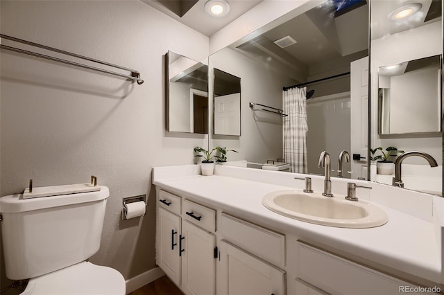 bathroom with toilet, vanity, and a shower with curtain