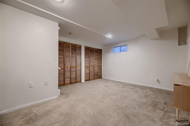 unfurnished bedroom with two closets and carpet