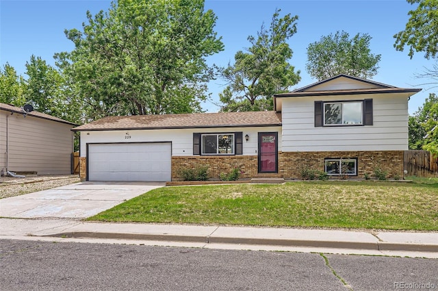 229 Ranae Dr, Loveland, CO 80537 - tri-level home featuring brick siding, an attached garage, and concrete driveway