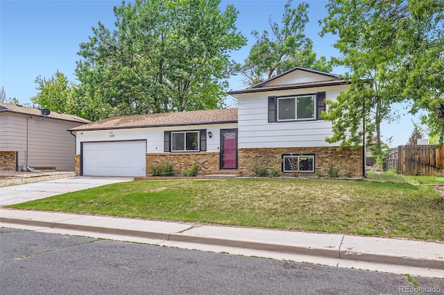 229 Ranae Dr, Loveland, CO 80537 - tri-level home featuring brick siding, an attached garage, and driveway