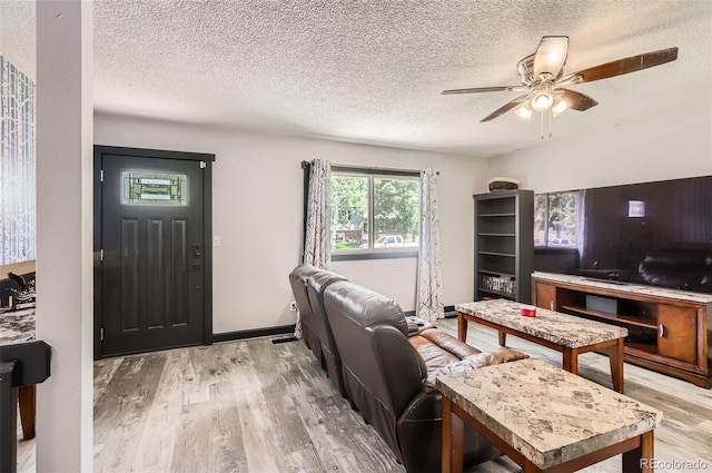 229 Ranae Dr, Loveland, CO 80537 - living area with light wood-style flooring, a textured ceiling, and a ceiling fan