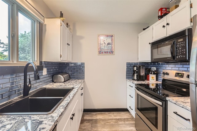 229 Ranae Dr, Loveland, CO 80537 - kitchen with electric stove, black microwave, a sink, and backsplash