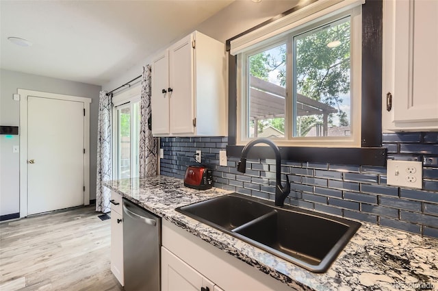 229 Ranae Dr, Loveland, CO 80537 - kitchen with a sink, dishwasher, and white cabinetry