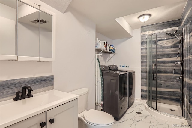 229 Ranae Dr, Loveland, CO 80537 - full bath with washer and clothes dryer, vanity, toilet, a stall shower, and marble look tile flooring