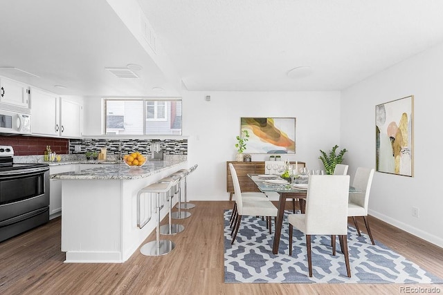 dining room with light hardwood / wood-style floors