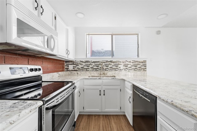 kitchen with sink, dishwasher, white cabinetry, electric range, and decorative backsplash