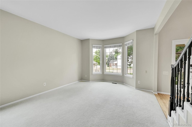 2316 Weatherstone Cir, Highlands Ranch, CO 80126 - unfurnished room featuring healthy amount of natural light, light colored carpet, and stairs