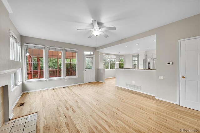 2316 Weatherstone Cir, Highlands Ranch, CO 80126 - unfurnished living room with a ceiling fan and light wood finished floors