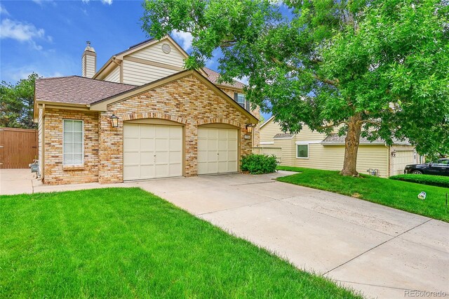 2316 Weatherstone Cir, Highlands Ranch, CO 80126 - traditional-style house featuring brick siding, a garage, a front yard, a chimney, and roof with shingles