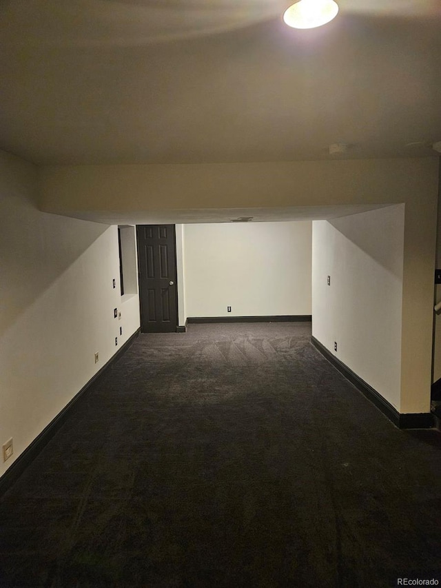 bonus room with dark colored carpet