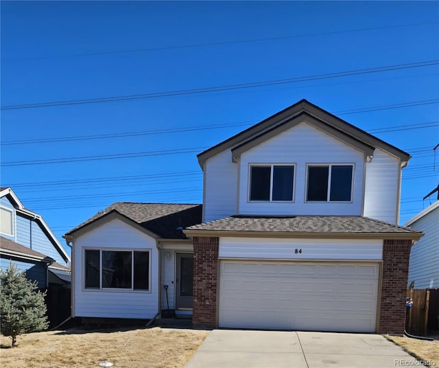 traditional-style house with a garage, brick siding, a shingled roof, fence, and concrete driveway