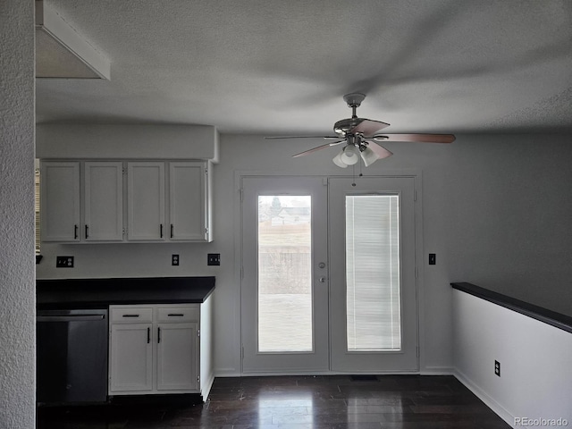 kitchen featuring a textured ceiling, white cabinets, french doors, dishwasher, and dark countertops