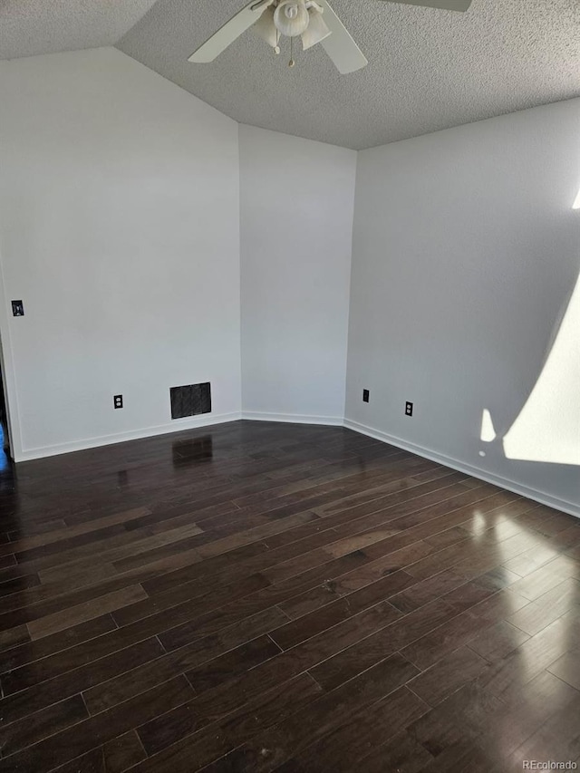 empty room with ceiling fan, a textured ceiling, visible vents, and dark wood-style flooring