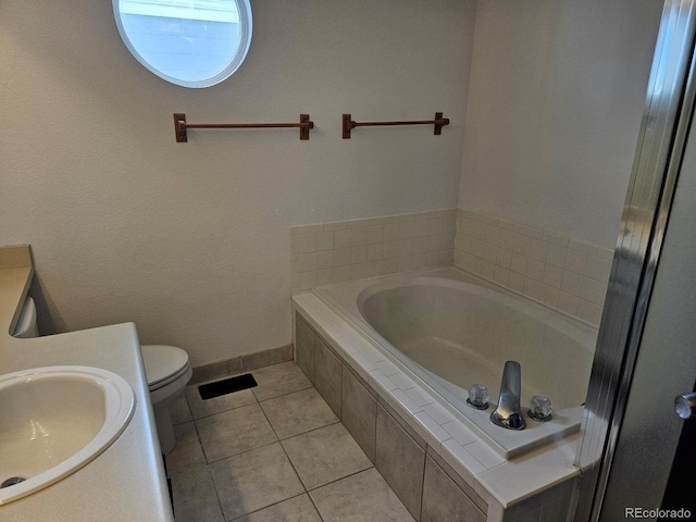 full bathroom featuring a garden tub, toilet, vanity, tile patterned flooring, and baseboards