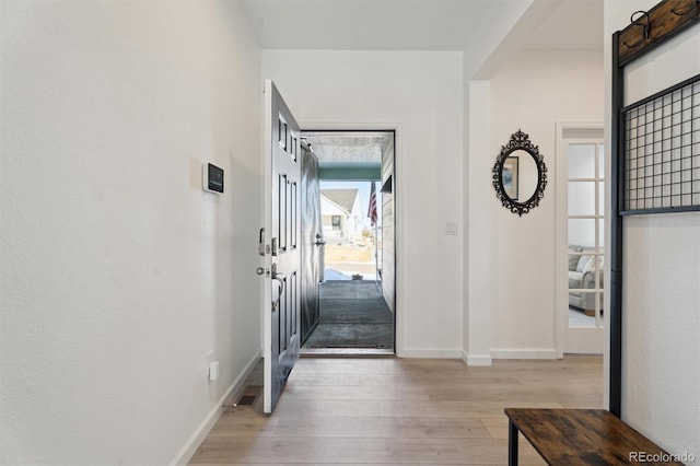 entrance foyer featuring light wood-type flooring and baseboards