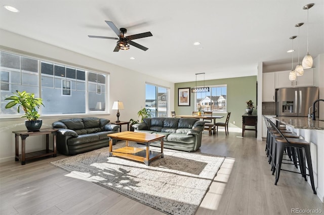 living area featuring recessed lighting, light wood-type flooring, baseboards, and ceiling fan