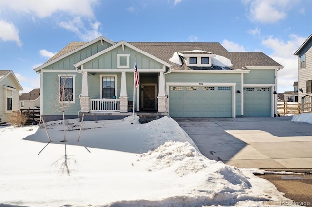 craftsman house featuring board and batten siding, a porch, concrete driveway, roof with shingles, and a garage