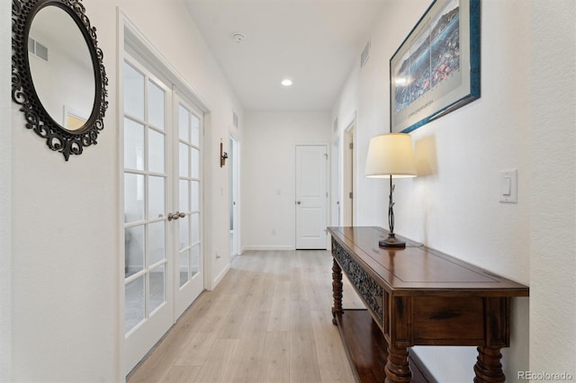 doorway to outside featuring french doors, baseboards, visible vents, and light wood finished floors