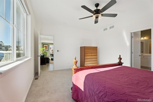 bedroom featuring visible vents, baseboards, light colored carpet, and a ceiling fan