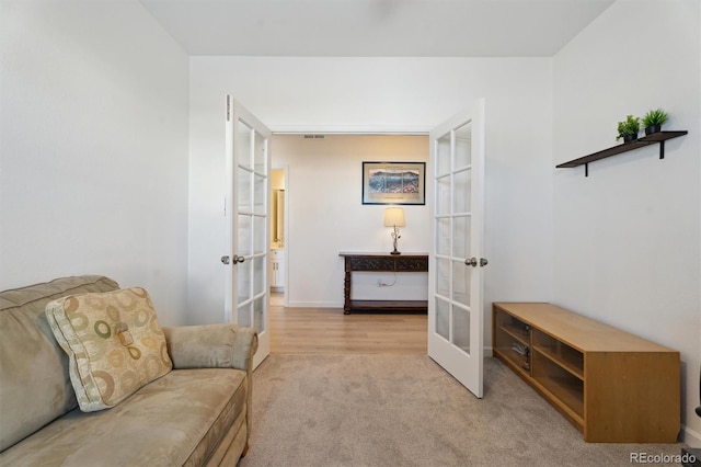 living area with carpet flooring and french doors