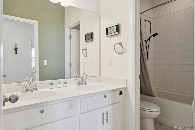 full bathroom with double vanity, toilet, shower / tub combo, and a sink