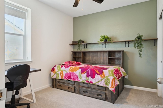 carpeted bedroom with a ceiling fan and baseboards