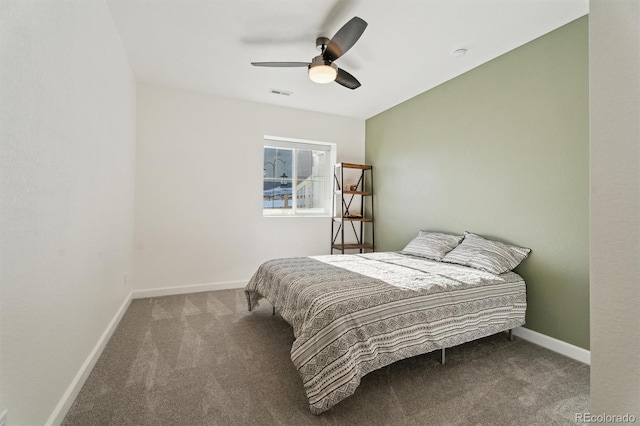 carpeted bedroom with a ceiling fan, baseboards, and visible vents