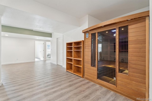 interior space featuring baseboards and wood finished floors