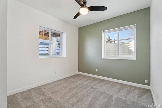 unfurnished room with baseboards, carpet, and a ceiling fan