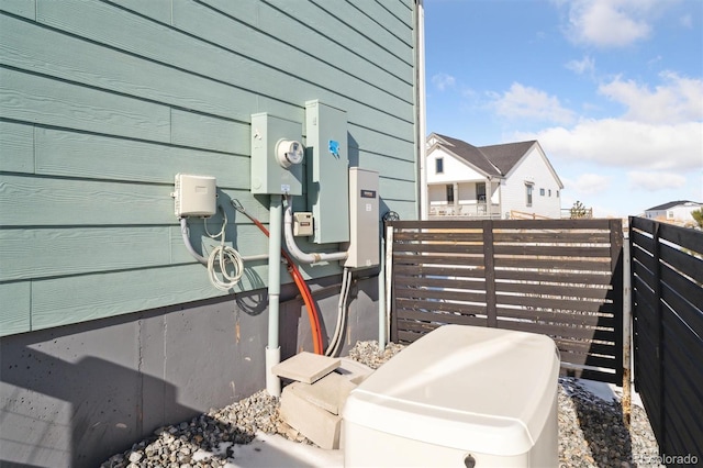 details featuring electric meter and fence