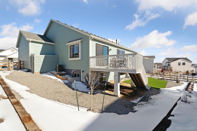 back of property with fence, central air condition unit, a residential view, a wooden deck, and stairs