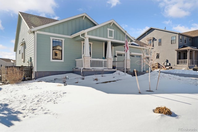 view of front of home with covered porch, board and batten siding, and a garage