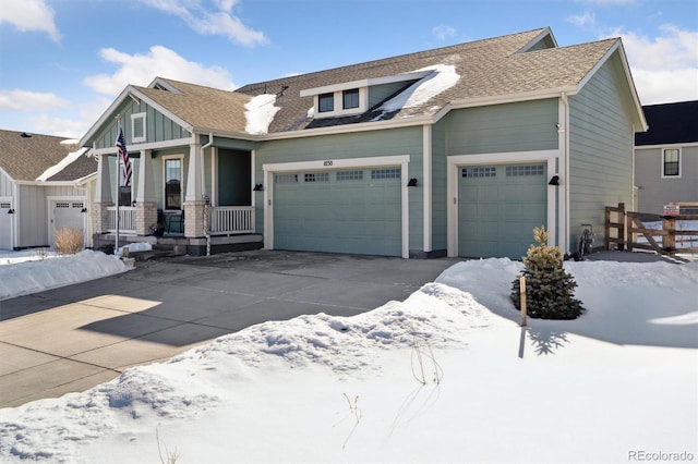 view of front of property featuring board and batten siding, concrete driveway, an attached garage, and covered porch