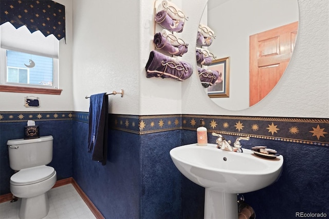 5723 S Everett Way, Littleton, CO 80123 - bathroom featuring toilet, tile patterned floors, and wainscoting