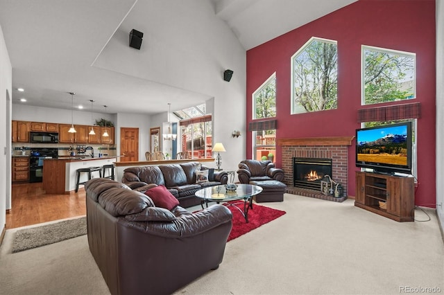 5723 S Everett Way, Littleton, CO 80123 - living area featuring a towering ceiling, a brick fireplace, recessed lighting, and carpet flooring