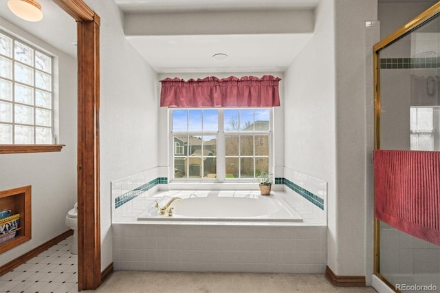 5723 S Everett Way, Littleton, CO 80123 - bathroom featuring toilet, a bath, a shower stall, and baseboards