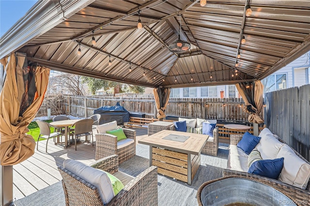 view of patio / terrace with a gazebo, grilling area, an outdoor living space, and a wooden deck