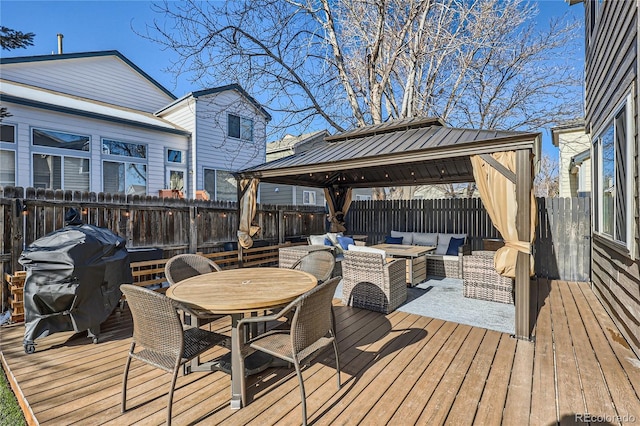 wooden terrace featuring a gazebo, area for grilling, and an outdoor living space