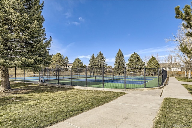 view of sport court with a yard