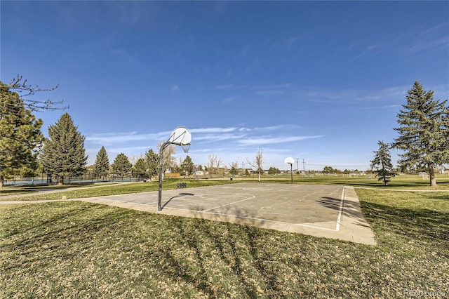 view of sport court with a lawn