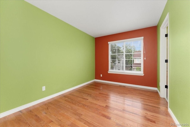 1241 S Akron Way, Denver, CO 80247 - spare room featuring light wood-style floors and baseboards