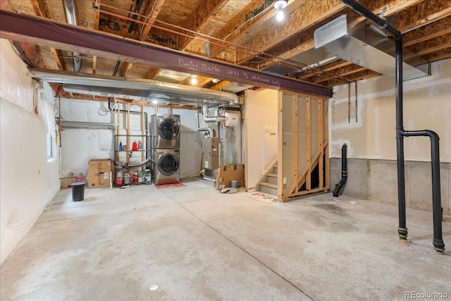 1241 S Akron Way, Denver, CO 80247 - unfinished basement featuring stacked washer / dryer, heating unit, and a heating unit