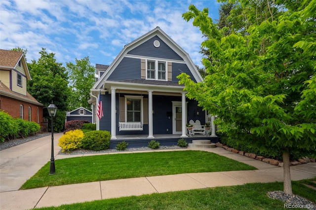 5675 S Crocker St, Littleton, CO 80120 - colonial inspired home featuring a gambrel roof, a porch, and a front yard
