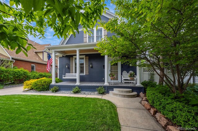 5675 S Crocker St, Littleton, CO 80120 - view of front of house with covered porch and a front lawn