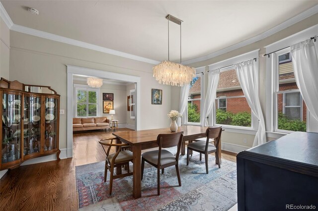 5675 S Crocker St, Littleton, CO 80120 - dining space featuring a chandelier, wood finished floors, crown molding, and baseboards